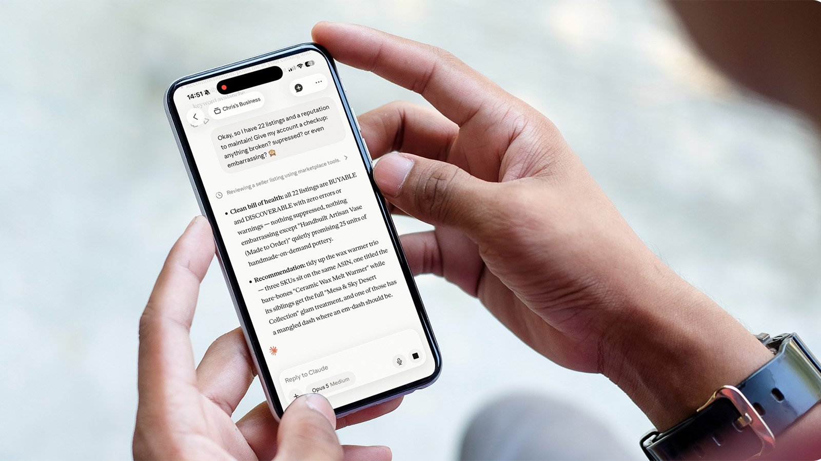 A person using Claude on a mobile phone to get updates from Amazon seller data